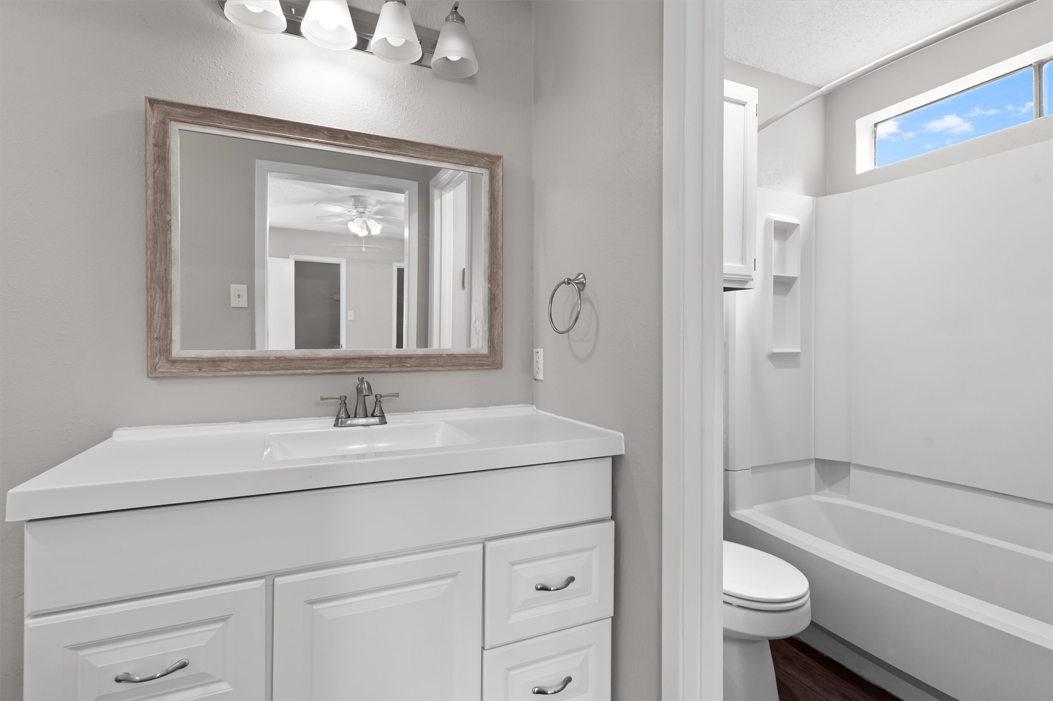 13357 Water Oak Lane, Unit A Austin, TX 78729 - Photo 12 of 26 a bathroom with a sink a toilet and shower