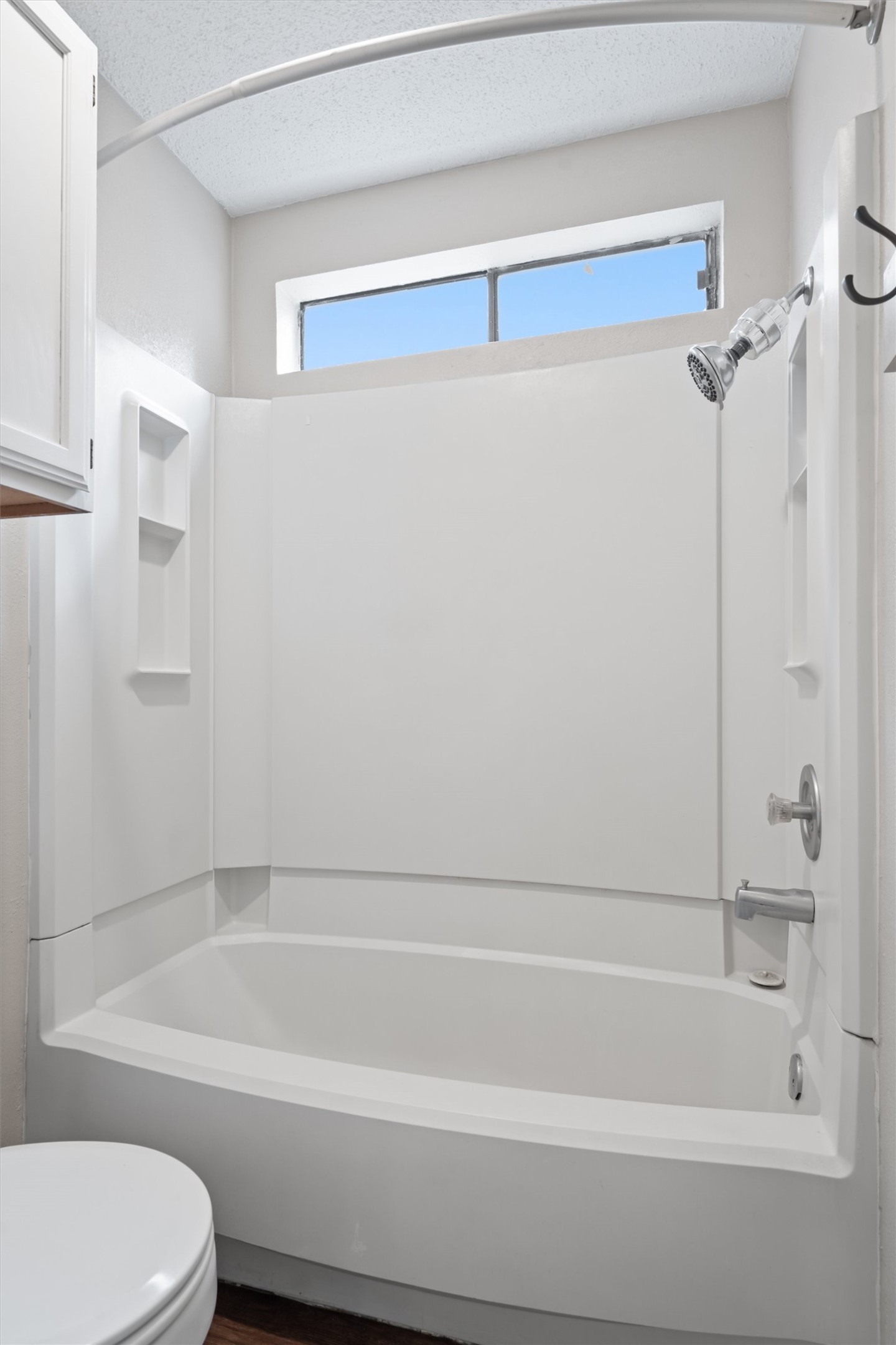 13357 Water Oak Lane, Unit A Austin, TX 78729 - Photo 13 of 26 a bathroom with a bathtub and a toilet
