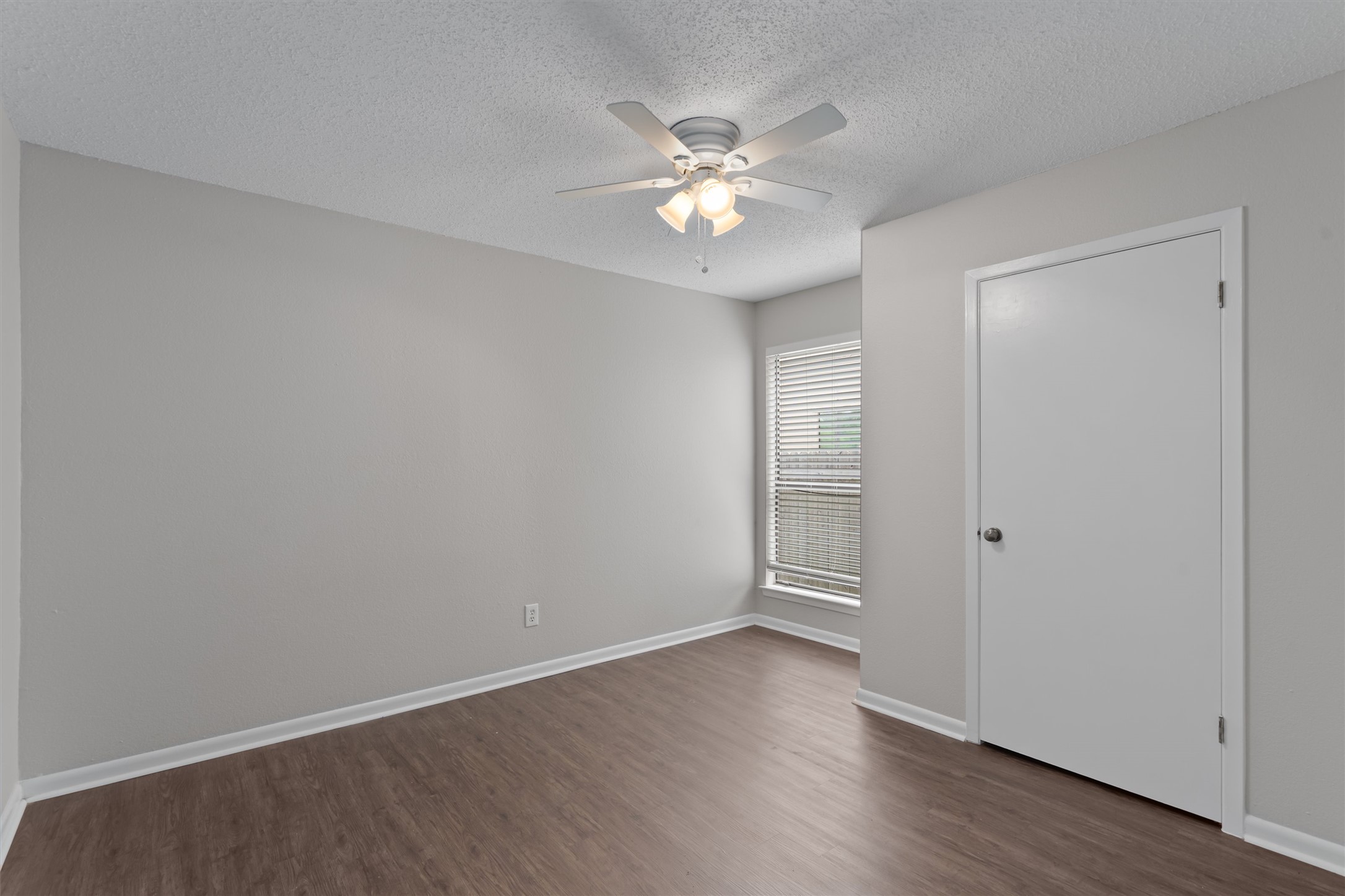 13357 Water Oak Lane, Unit A Austin, TX 78729 - Photo 15 of 26 a view of an empty room with wooden floor