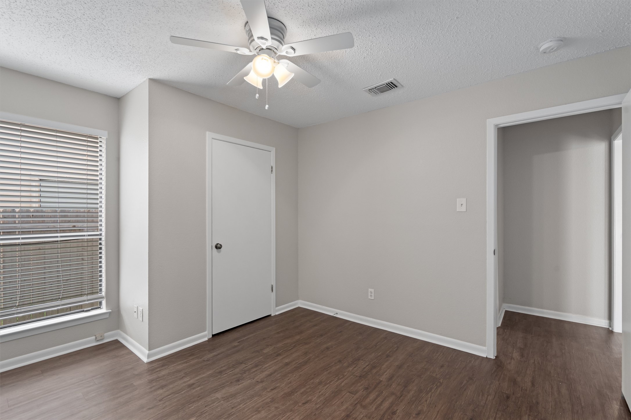 13357 Water Oak Lane, Unit A Austin, TX 78729 - Photo 16 of 26 wooden floor in an empty room with a window