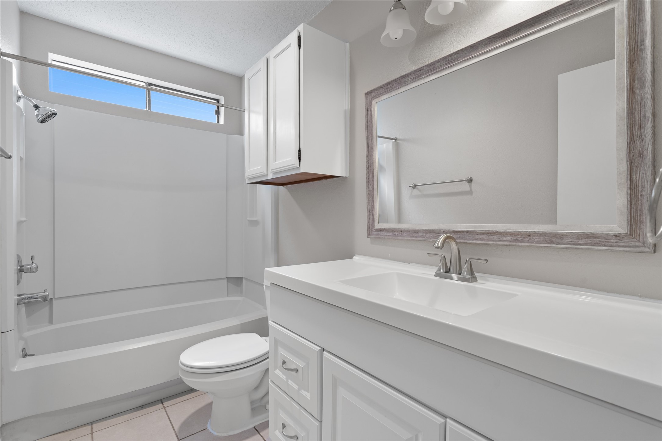 13357 Water Oak Lane, Unit A Austin, TX 78729 - Photo 17 of 26 a bathroom with a sink a toilet and a bathtub