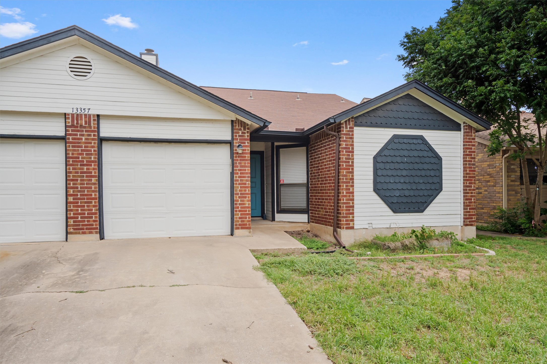 13357 Water Oak Lane, Unit A Austin, TX 78729 - Photo 25 of 26 a front view of a house with a yard and garage