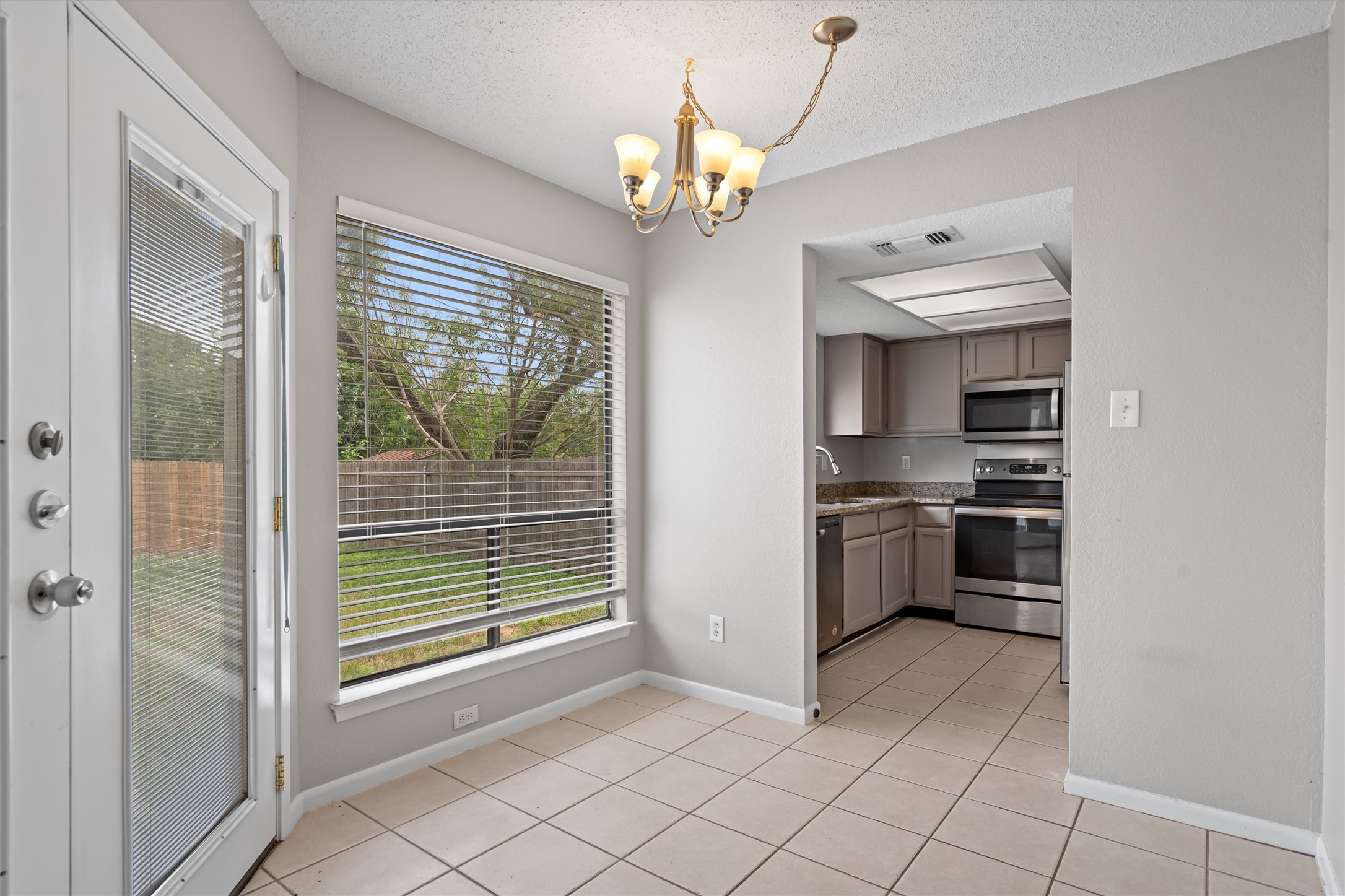 13357 Water Oak Lane, Unit A Austin, TX 78729 - Photo 5 of 26 a kitchen with a refrigerator and a sink