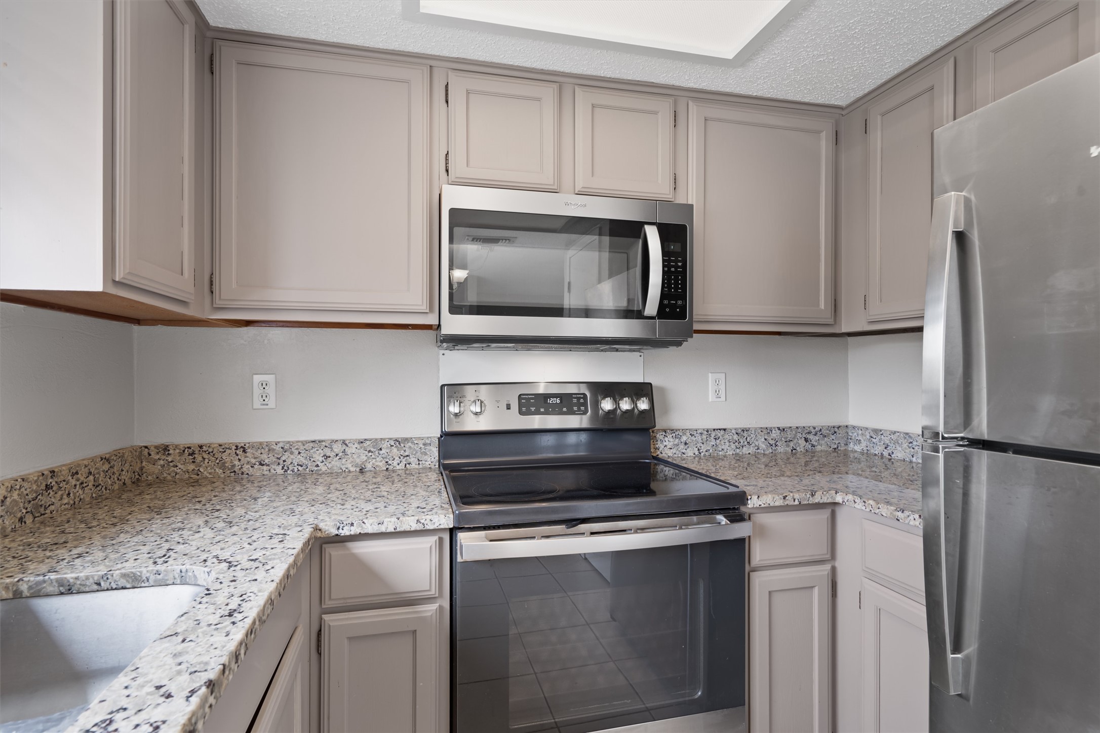 13357 Water Oak Lane, Unit A Austin, TX 78729 - Photo 8 of 26 a kitchen with appliances cabinets and a counter top space