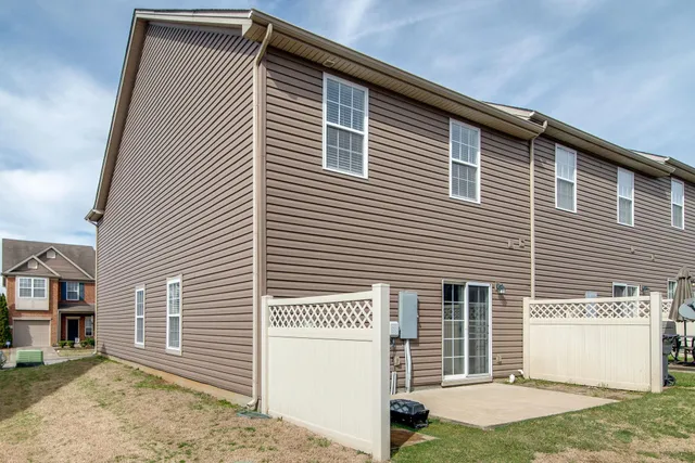 a view of a house with a yard and garage
