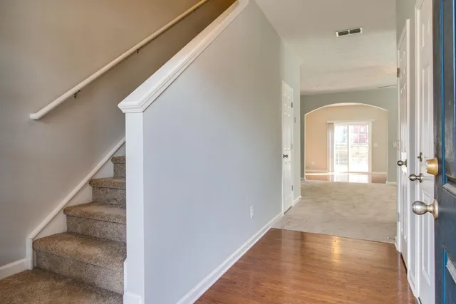 a view of a hallway view with wooden floor and staircase