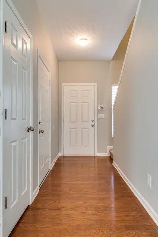 a view of an empty room with wooden floor