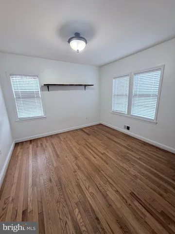 a view of hallway with wooden floor