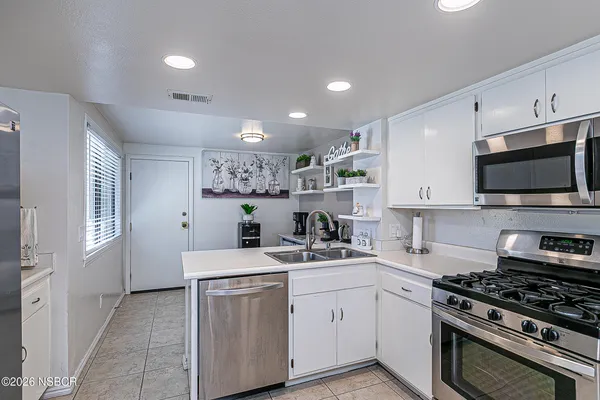 a kitchen with a sink stove and microwave