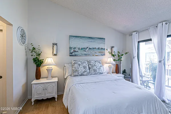a bedroom with a bed and a painting on the wall