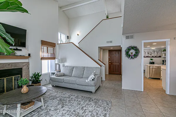 a living room with furniture and a fireplace