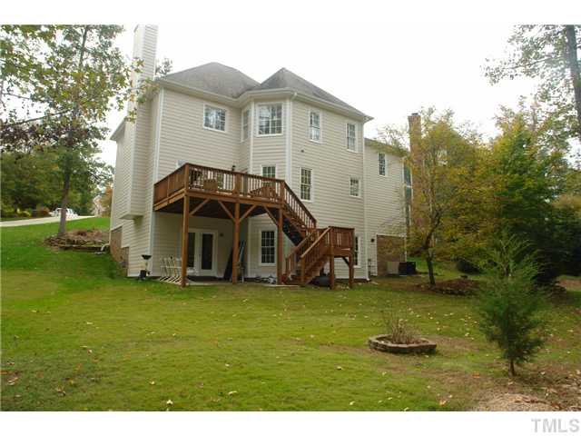 4612 Groundnut Court Raleigh, NC 27613 - Photo 11 of 12 a view of a big house with a big yard and large trees