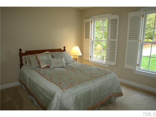 4612 Groundnut Court Raleigh, NC 27613 - Photo 10 of 12 a bed sitting in a bedroom next to a window