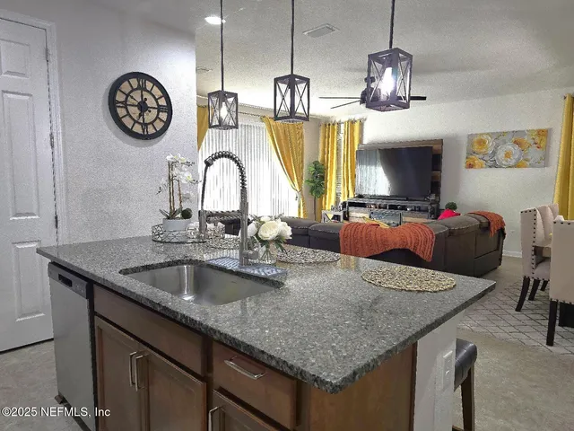 a kitchen with a dining table chairs and kitchen view