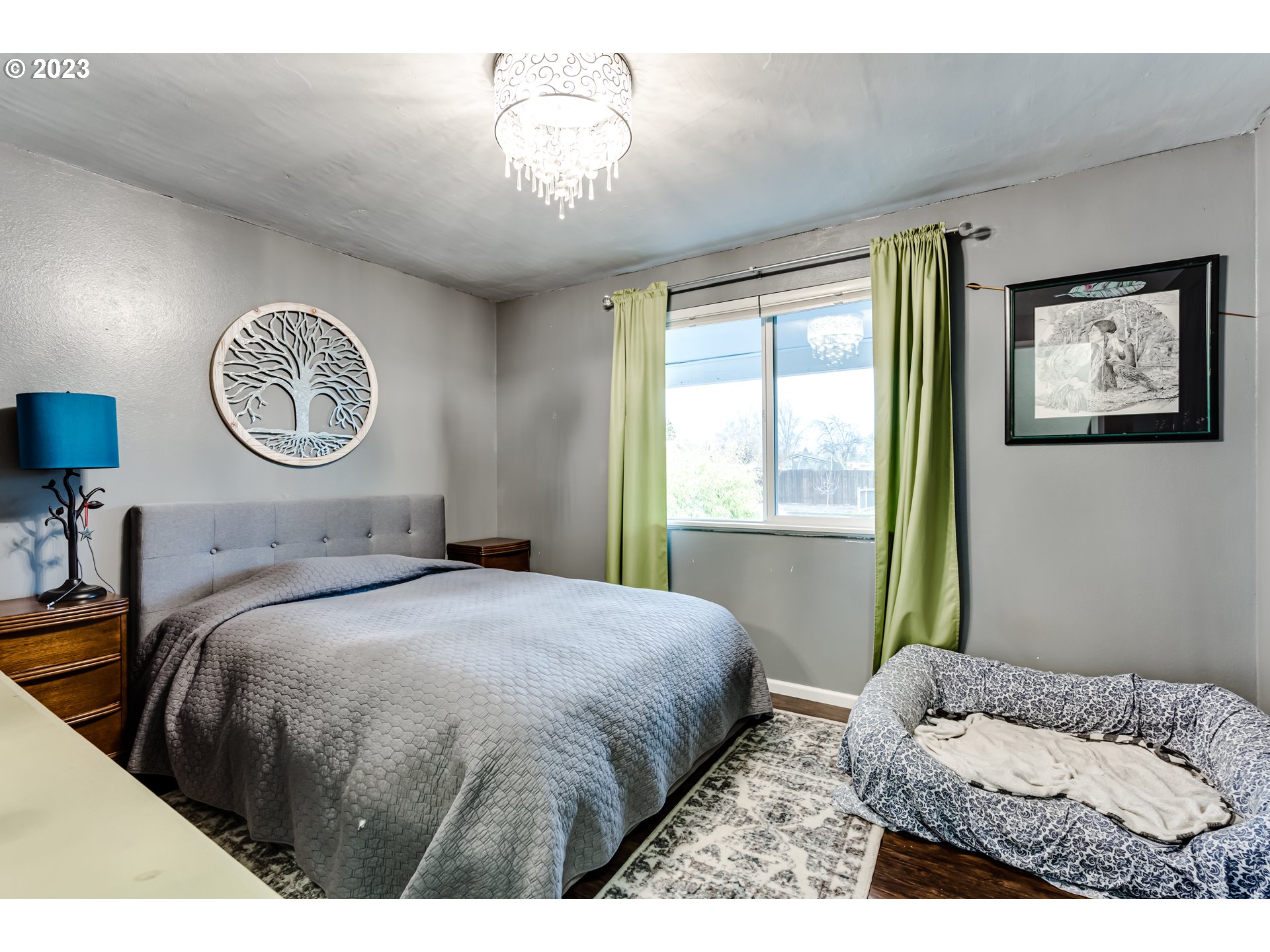 1023 57th Street Springfield, OR 97478 - Photo 14 of 21 a bedroom with a bed and a chandelier