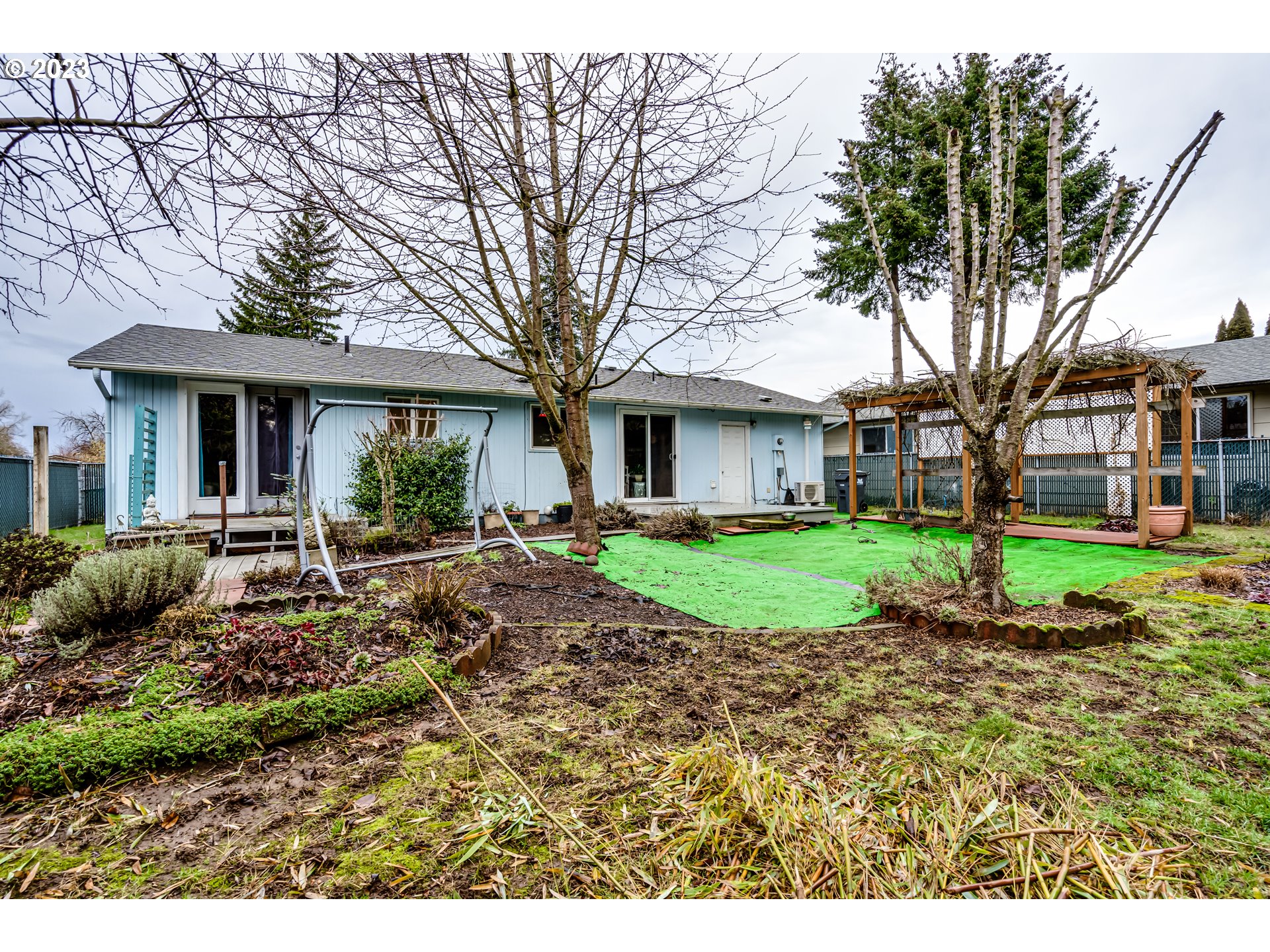 1023 57th Street Springfield, OR 97478 - Photo 17 of 21 a view of a house with a yard and large trees