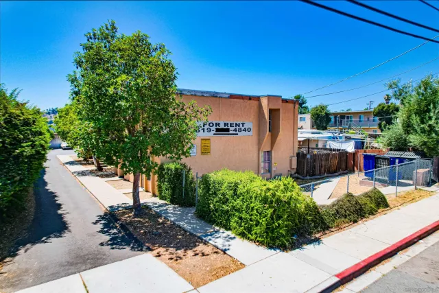 a backyard of a house with yard and outdoor seating