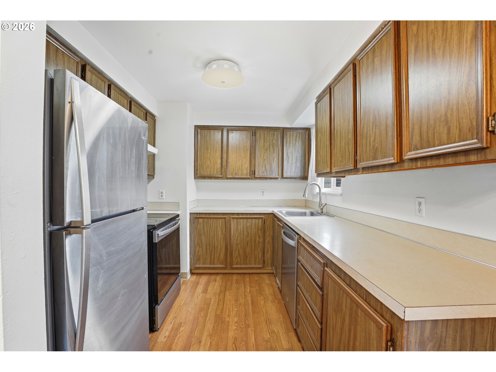 3537 Southeast 64th Avenue Portland, OR 97206 - Photo 11 of 32 a kitchen with a refrigerator sink and cabinets
