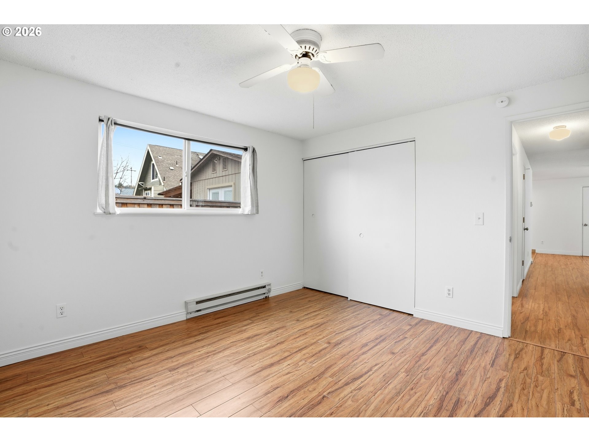3537 Southeast 64th Avenue Portland, OR 97206 - Photo 15 of 32 an empty room with wooden floor and ceiling fan