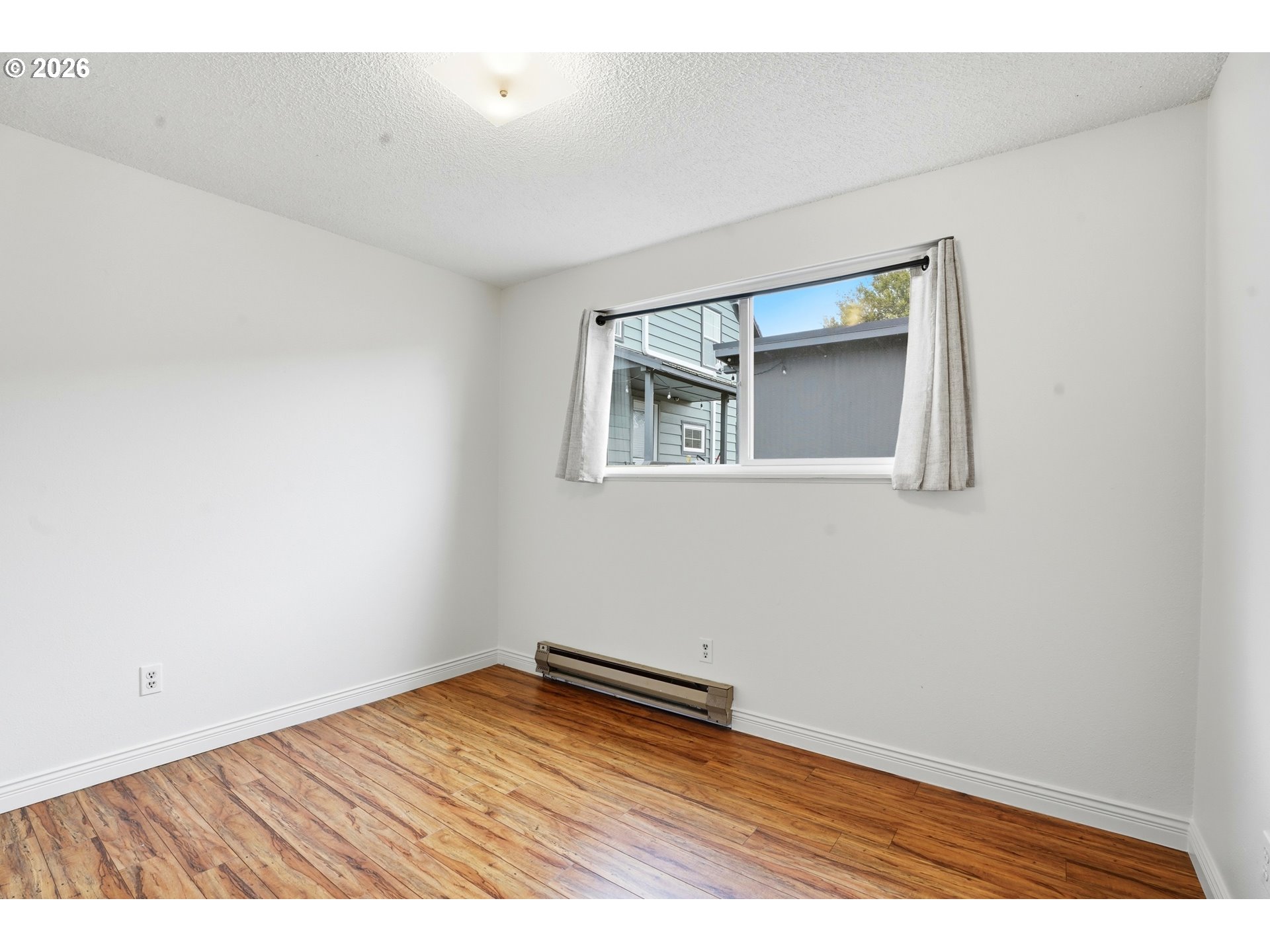 3537 Southeast 64th Avenue Portland, OR 97206 - Photo 20 of 32 an empty room with wooden floor and windows
