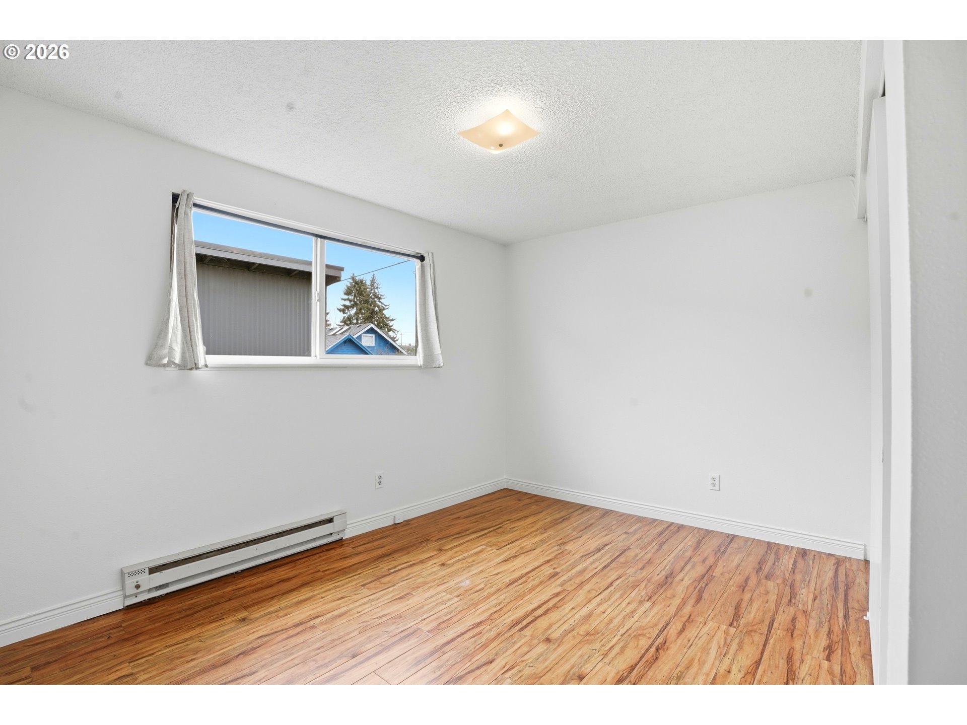 3537 Southeast 64th Avenue Portland, OR 97206 - Photo 23 of 32 a view of an empty room with wooden floor and a window