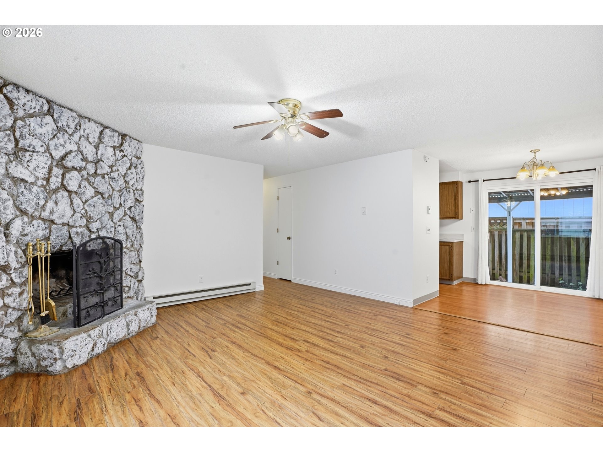 3537 Southeast 64th Avenue Portland, OR 97206 - Photo 4 of 32 a view of empty room with wooden floor and fireplace
