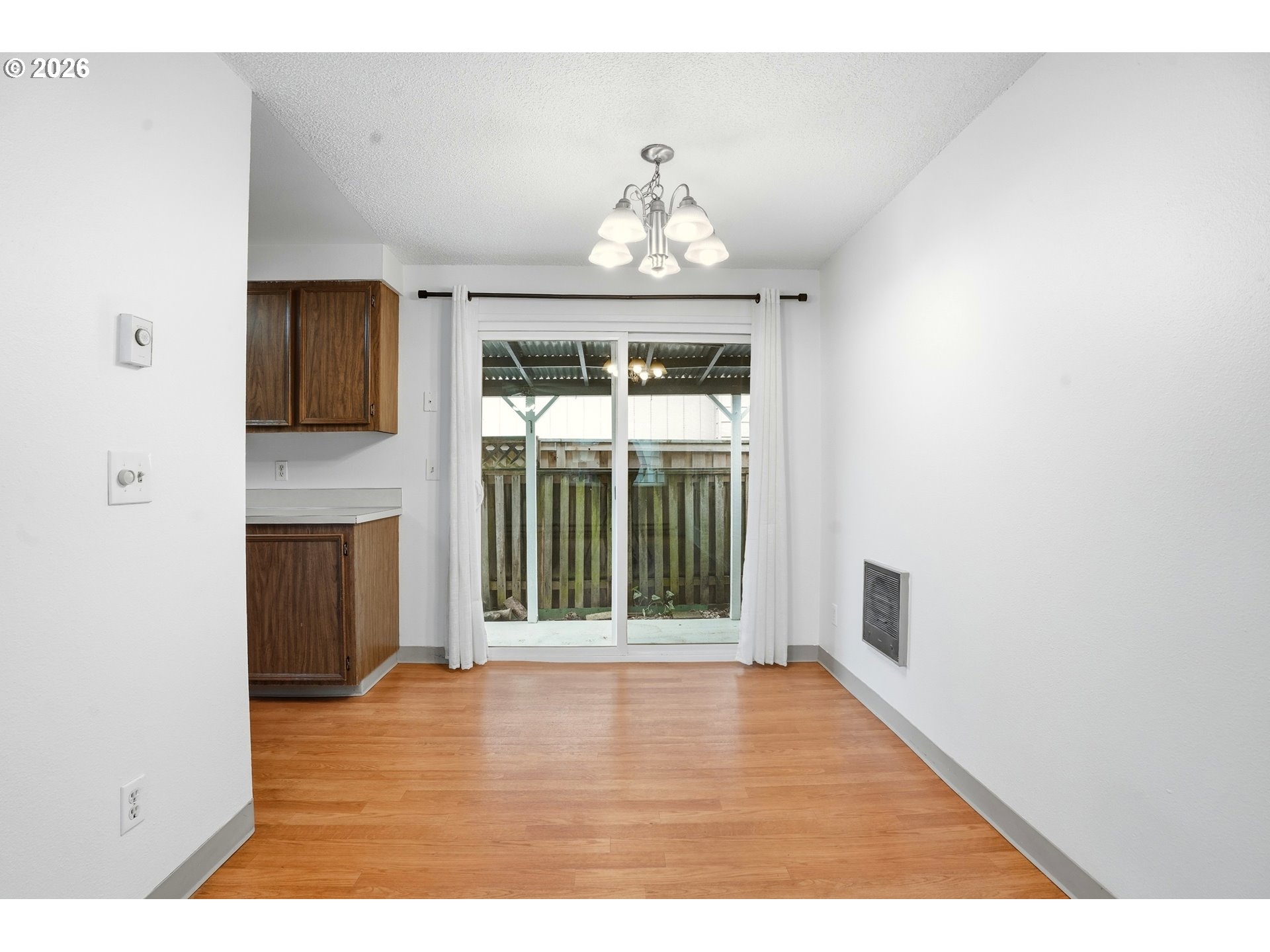 3537 Southeast 64th Avenue Portland, OR 97206 - Photo 8 of 32 a view of an empty room with wooden floor and a window