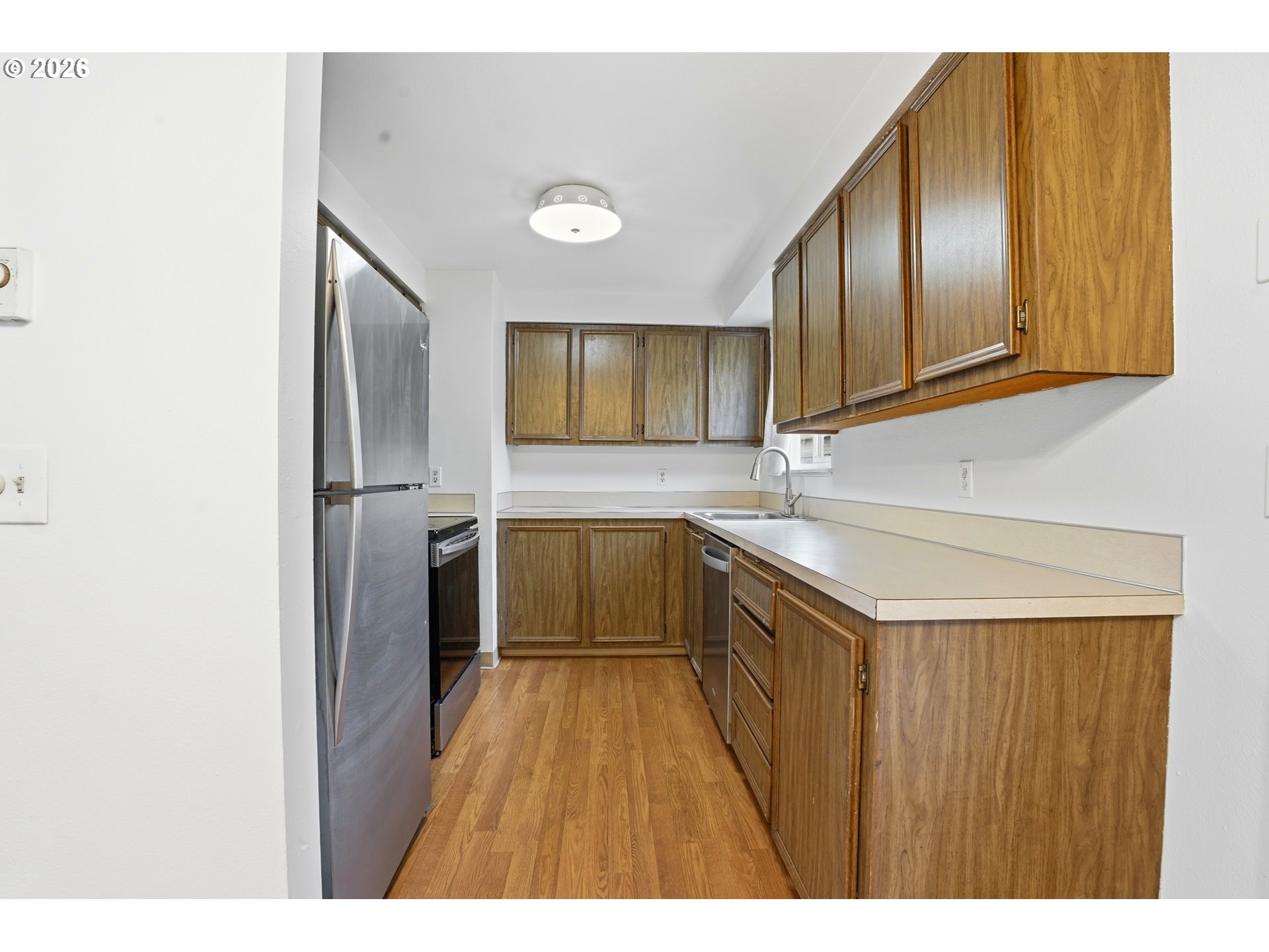 3537 Southeast 64th Avenue Portland, OR 97206 - Photo 10 of 32 a kitchen with a sink cabinets and stainless steel appliances