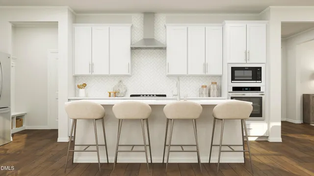 a kitchen with a dining table chairs and white cabinets