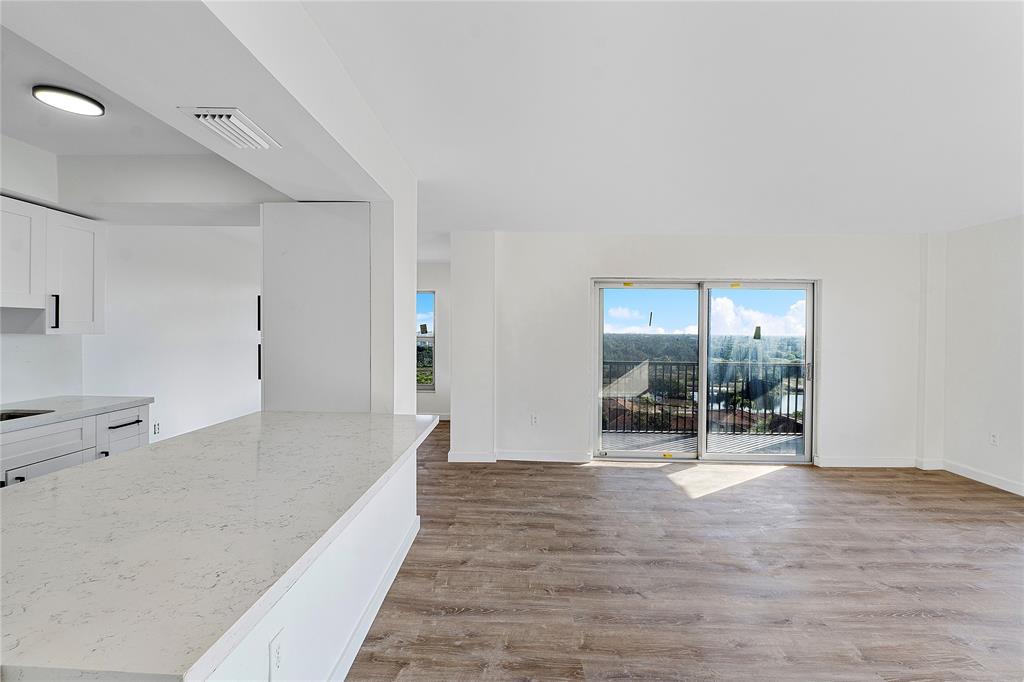 4174 Inverrary Drive, Unit 1002 Lauderhill, FL 33319 - Photo 12 of 28 a view of a big room with wooden floor and windows