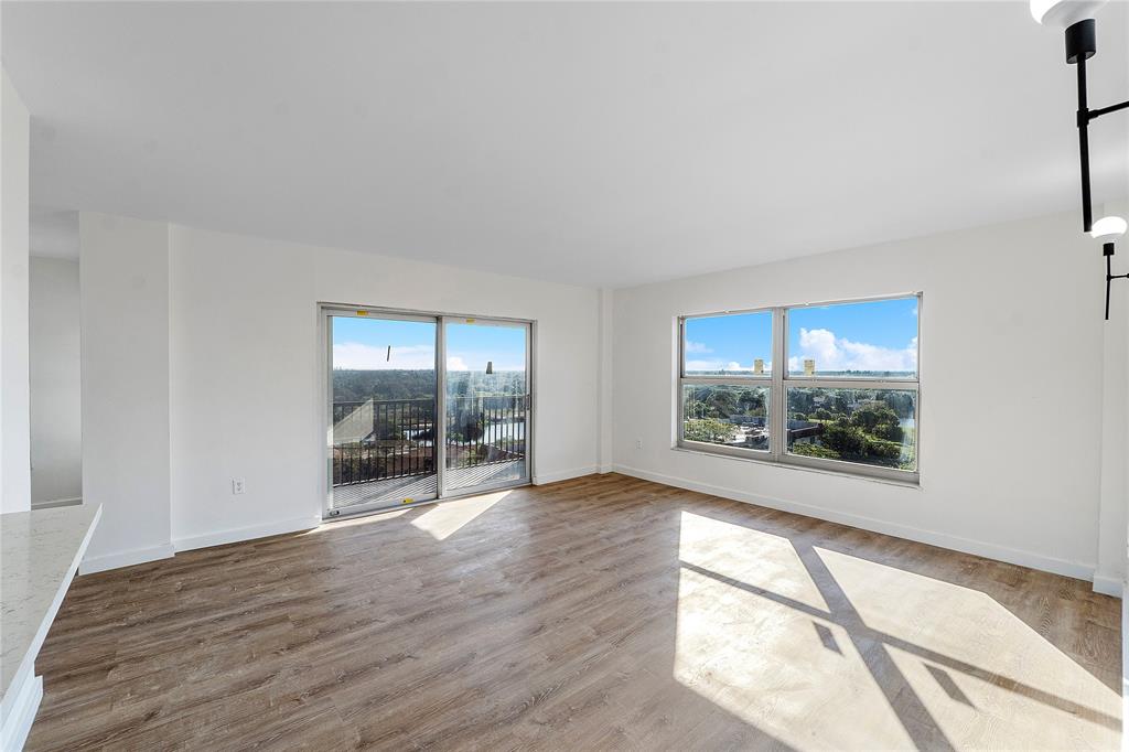 4174 Inverrary Drive, Unit 1002 Lauderhill, FL 33319 - Photo 14 of 28 an empty room with wooden floor and windows