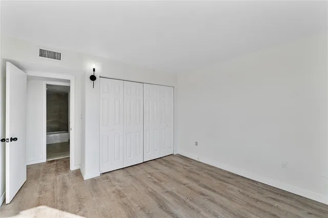 a view of a big room with closet and wooden floor