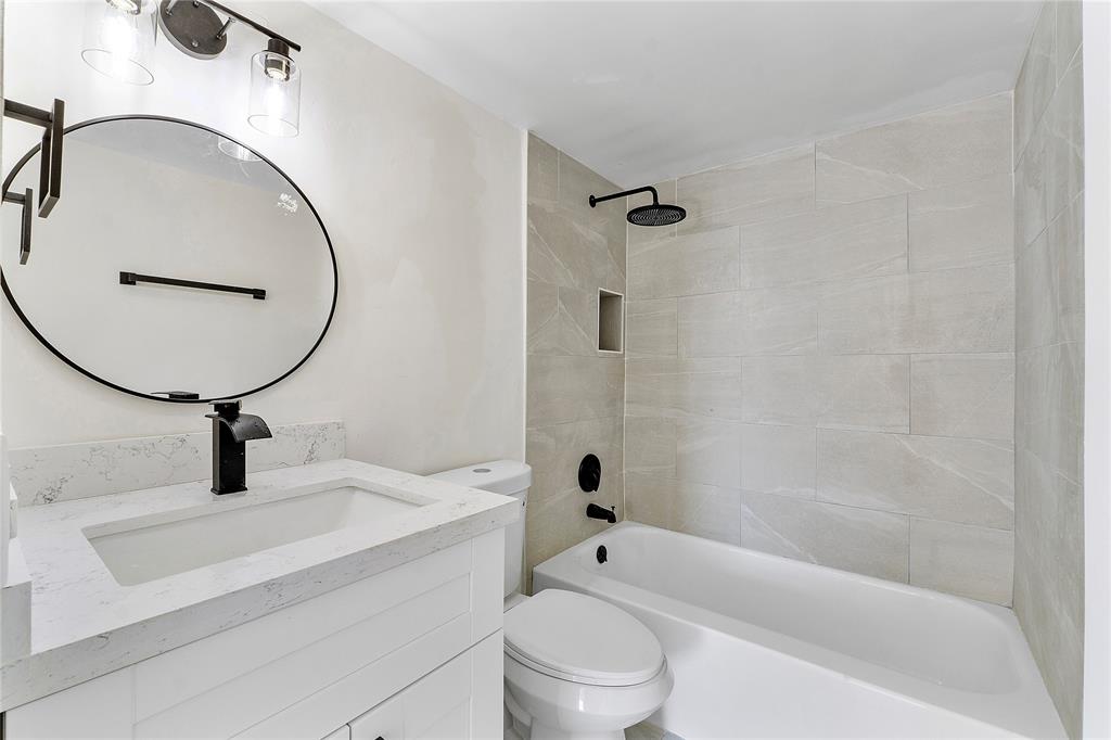 4174 Inverrary Drive, Unit 1002 Lauderhill, FL 33319 - Photo 18 of 28 a bathroom with a toilet sink and a mirror