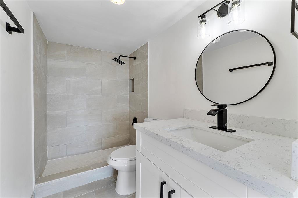4174 Inverrary Drive, Unit 1002 Lauderhill, FL 33319 - Photo 21 of 28 a bathroom with a sink a toilet and a mirror