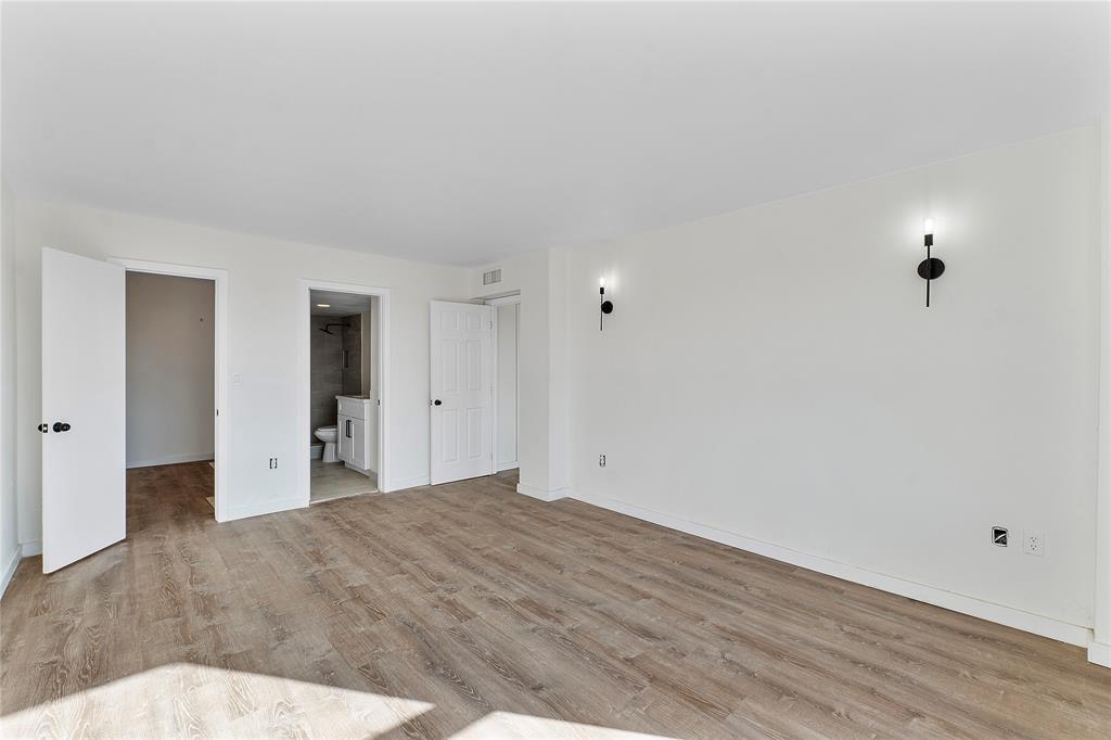 4174 Inverrary Drive, Unit 1002 Lauderhill, FL 33319 - Photo 23 of 28 a view of a big room with closet and wooden floor
