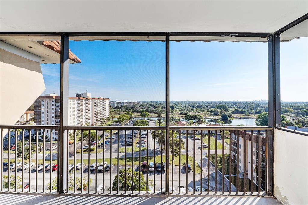 4174 Inverrary Drive, Unit 1002 Lauderhill, FL 33319 - Photo 25 of 28 a view of a balcony with floor to ceiling window stairs and wooden floor