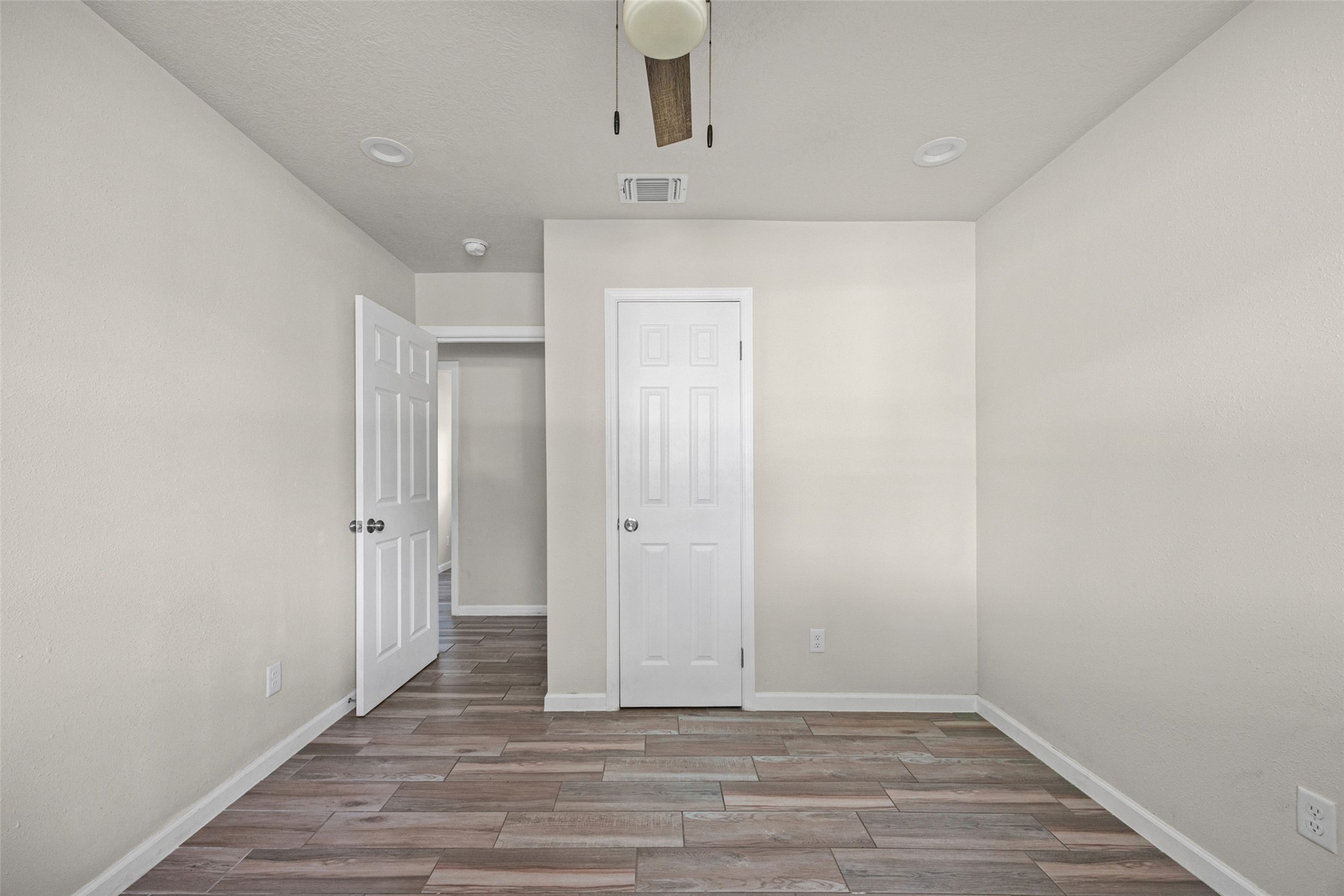 1531 Lahn Road New Braunfels, TX 78130 - Photo 18 of 33 Plank flooring and recessed lighting define this versatile, neutral bedroom space.
