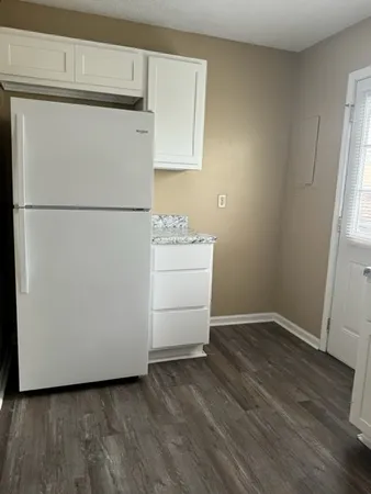 a white refrigerator freezer sitting in a kitchen