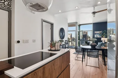 a kitchen with a table chairs stove and wooden floor