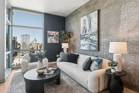 a living room with furniture and a wooden floor