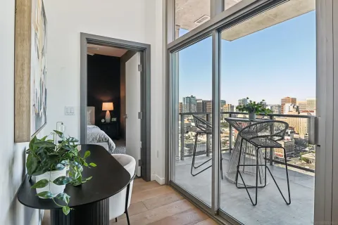 a table with chairs and potted plants on the wall