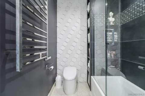 a bathroom with a toilet and a shower