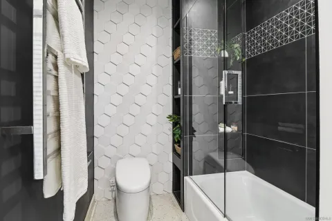 a bathroom with a toilet and a shower