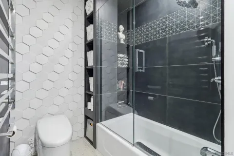 a bathroom with a toilet and a shower