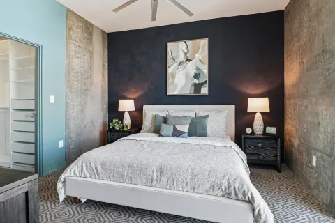 a bedroom with bed and wall painting