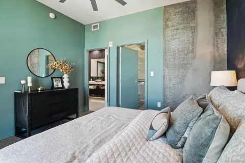 a bedroom with a bed and a chandelier