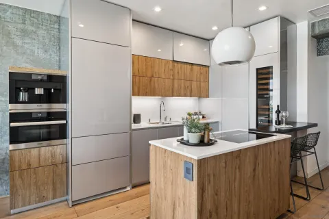 a kitchen with stainless steel appliances granite countertop a sink a microwave a refrigerator and a stove