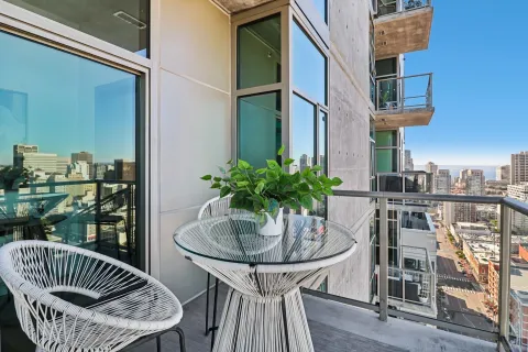 a balcony with table and chairs