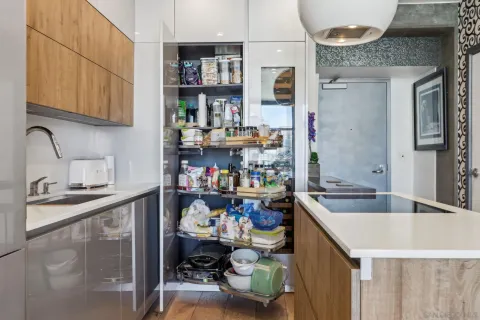 a kitchen that has a lot of cabinets a sink and a stove