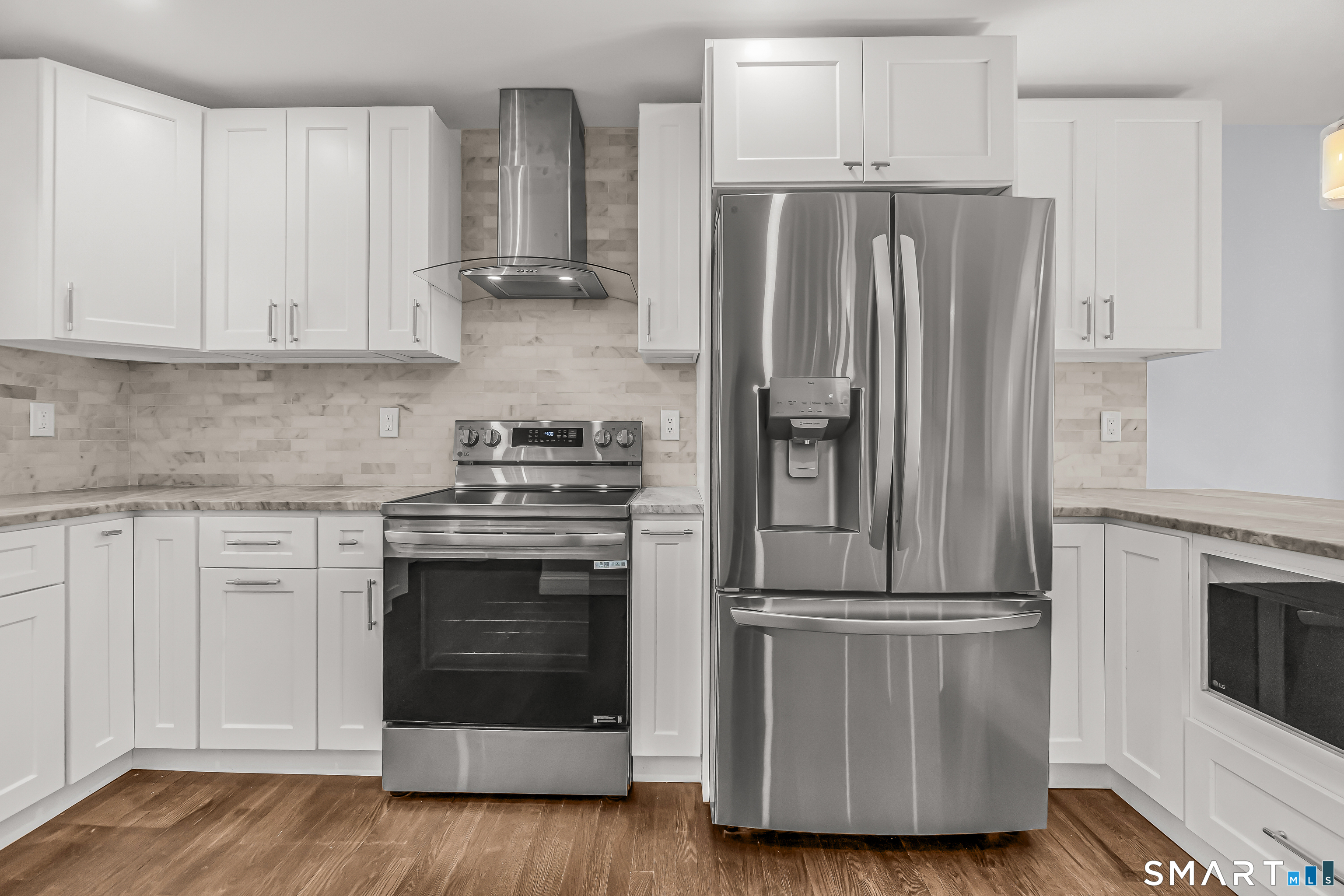 1770 Stratfield Road Fairfield, CT 06825 - Photo 16 of 40 a kitchen with cabinets stainless steel appliances and wooden floor
